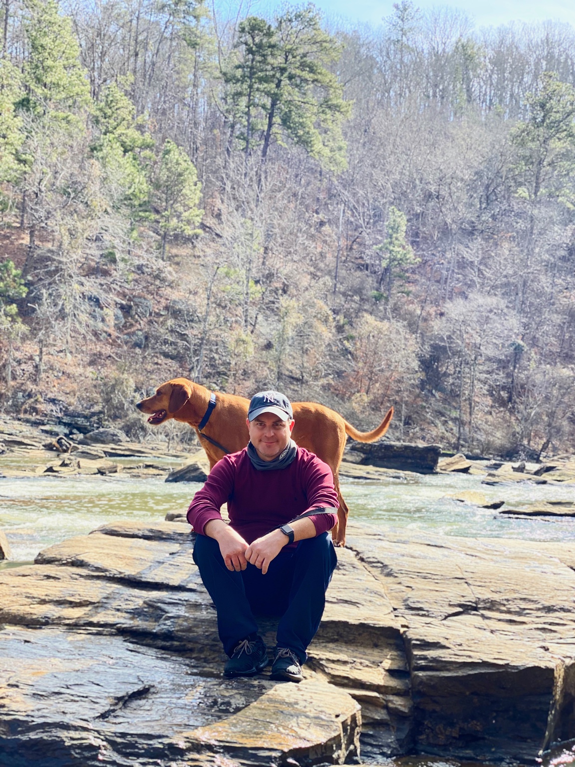 Chris and a dog beside the river